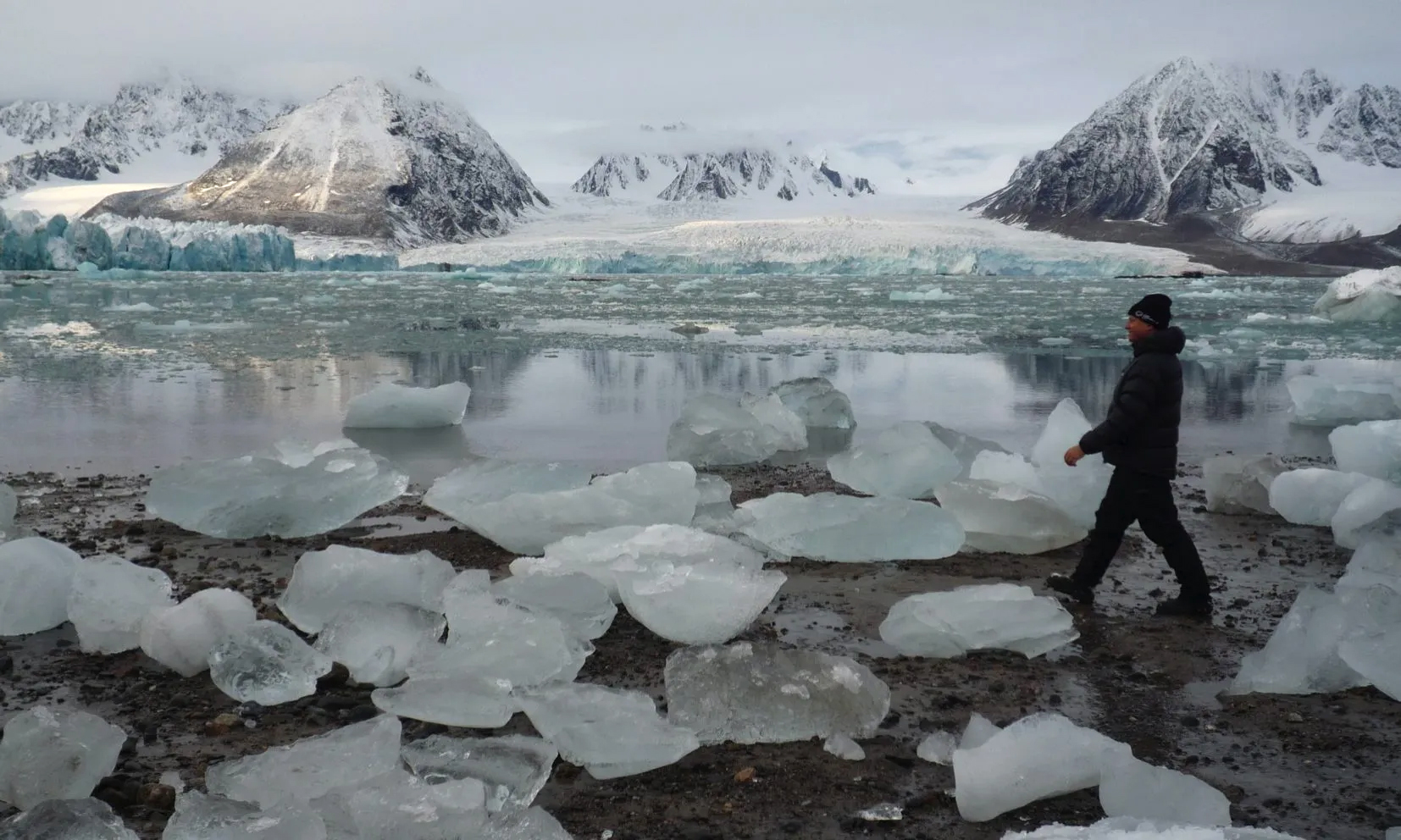 man walks in Arctic landscape