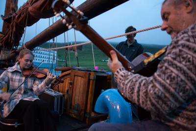 musicians play on boat deck