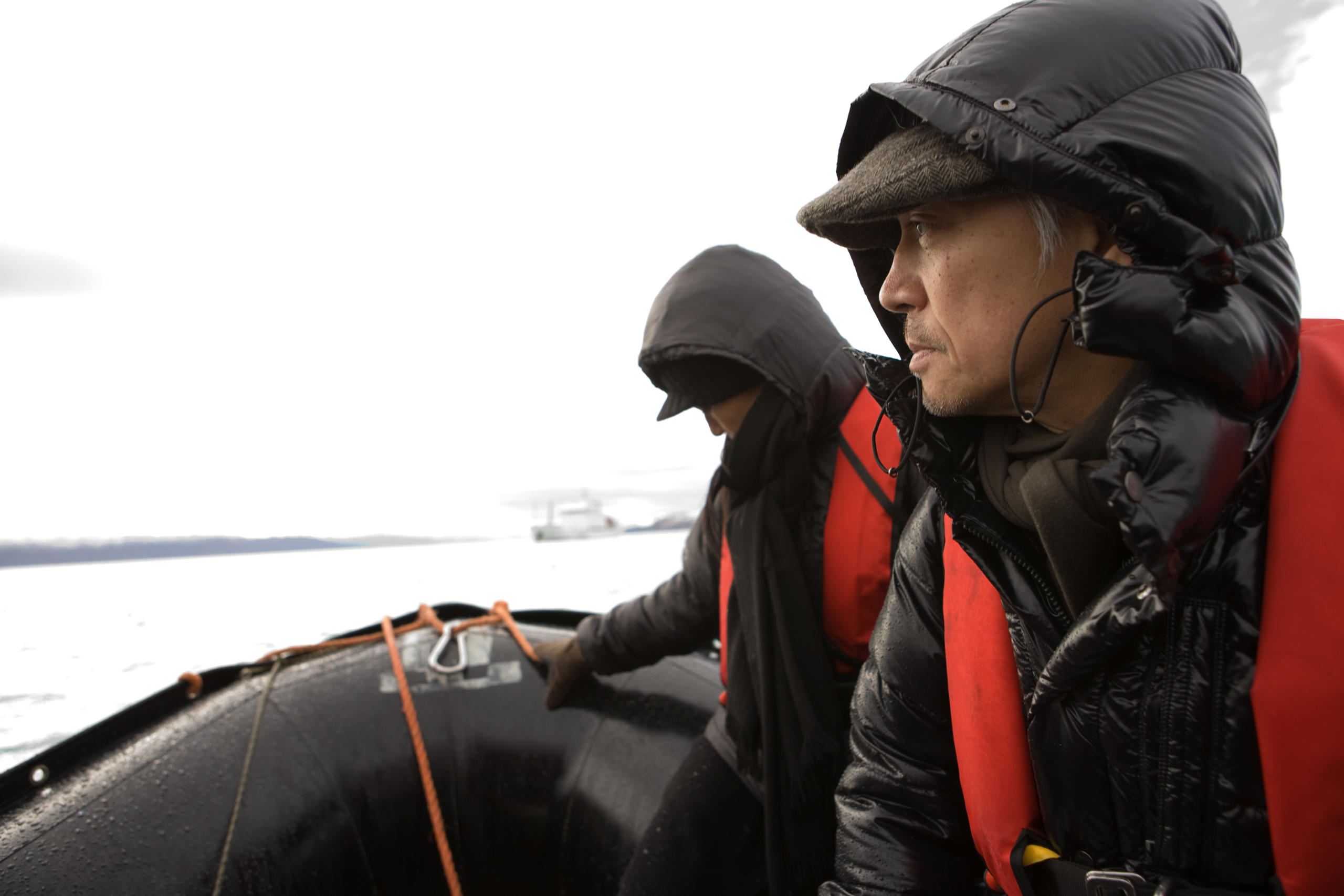 figures in Arctic gear onboard a zodiak