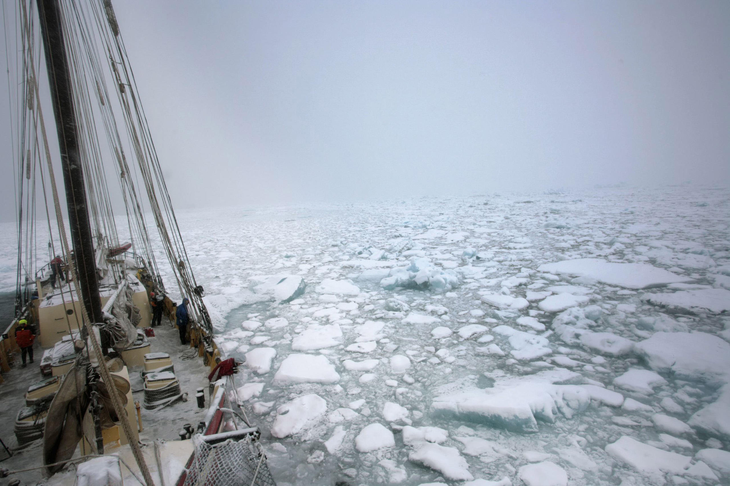 boat sailing through heavy ice in Arctic waters