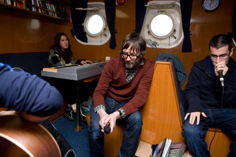 musicians jamming in a boat cabin