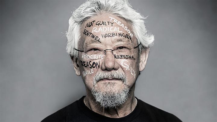 portrait of David Suzuki with "guilty, rational, radical" painted on his face