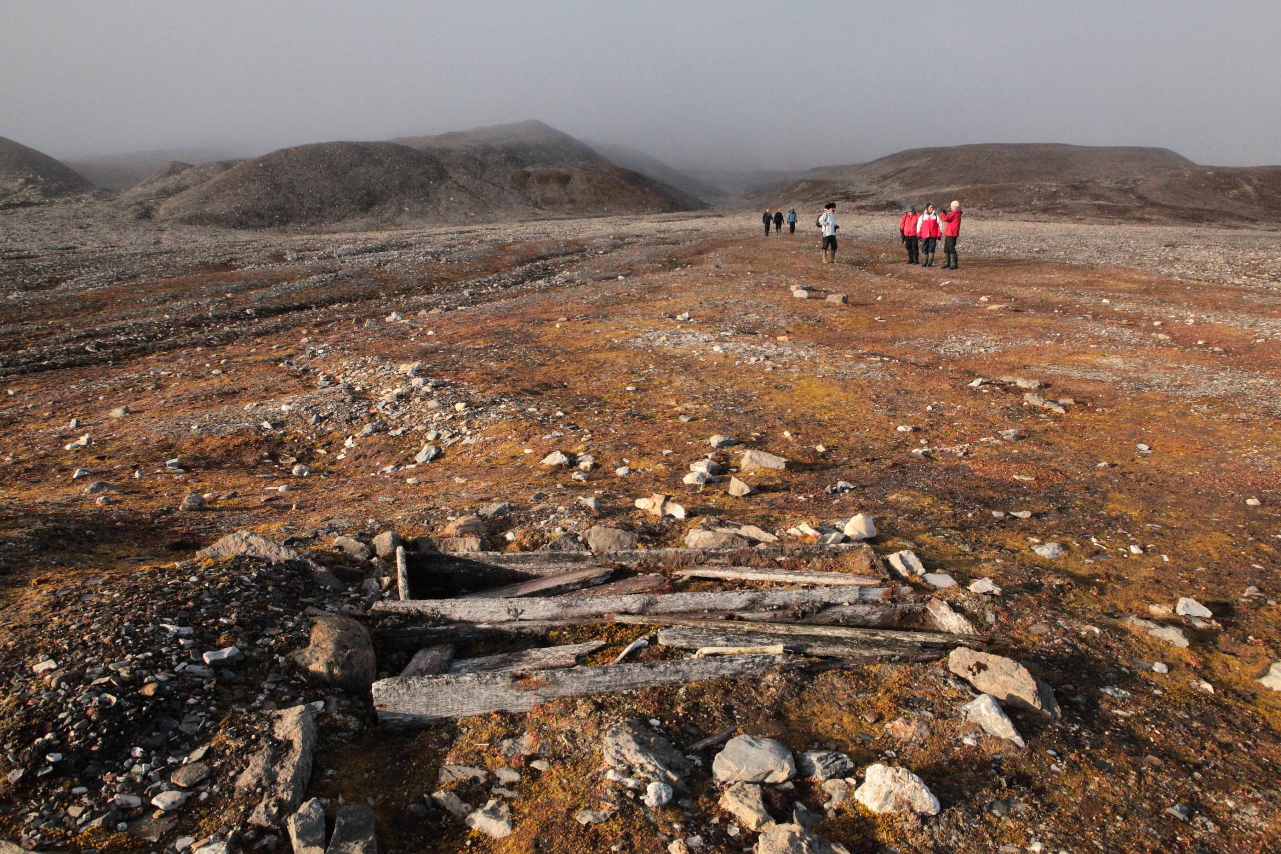 figures in vast tundra landscape