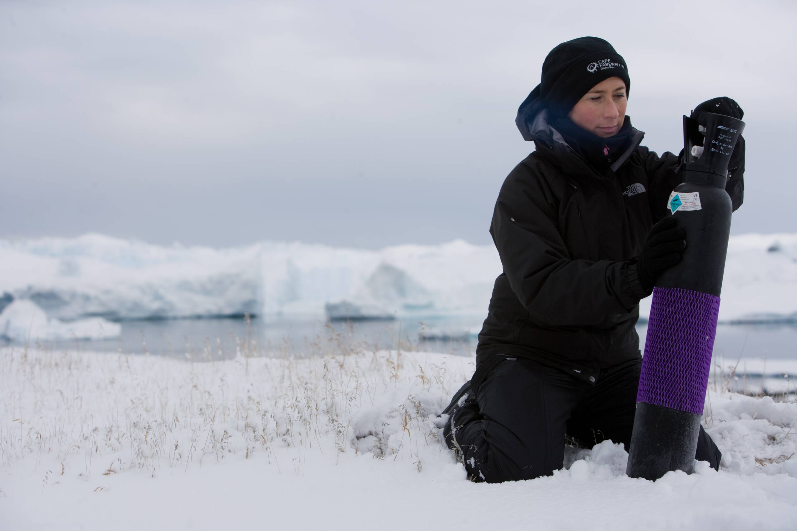 woman with gas cylinder in an Arctic environment