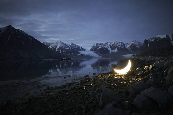 glowing moon sculpture in Arctic landscape