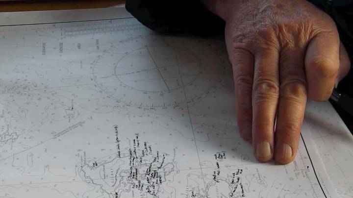 hand tracing a map