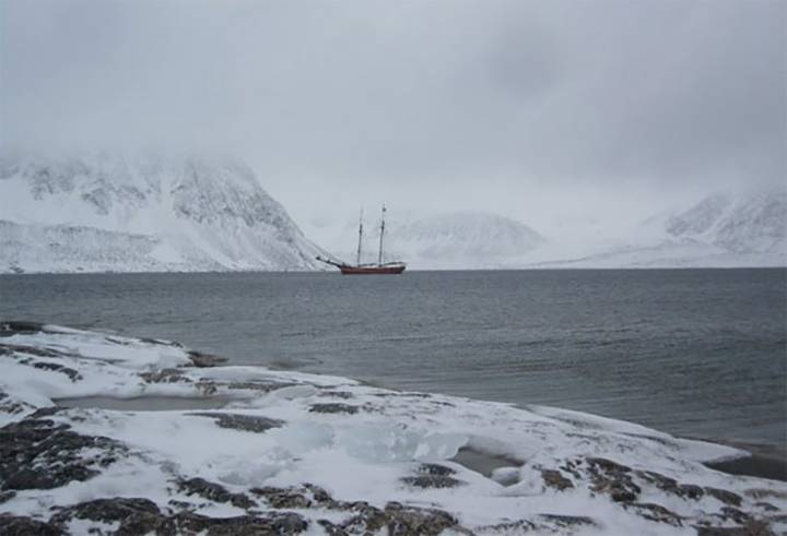 sailing boat in arctic landscape