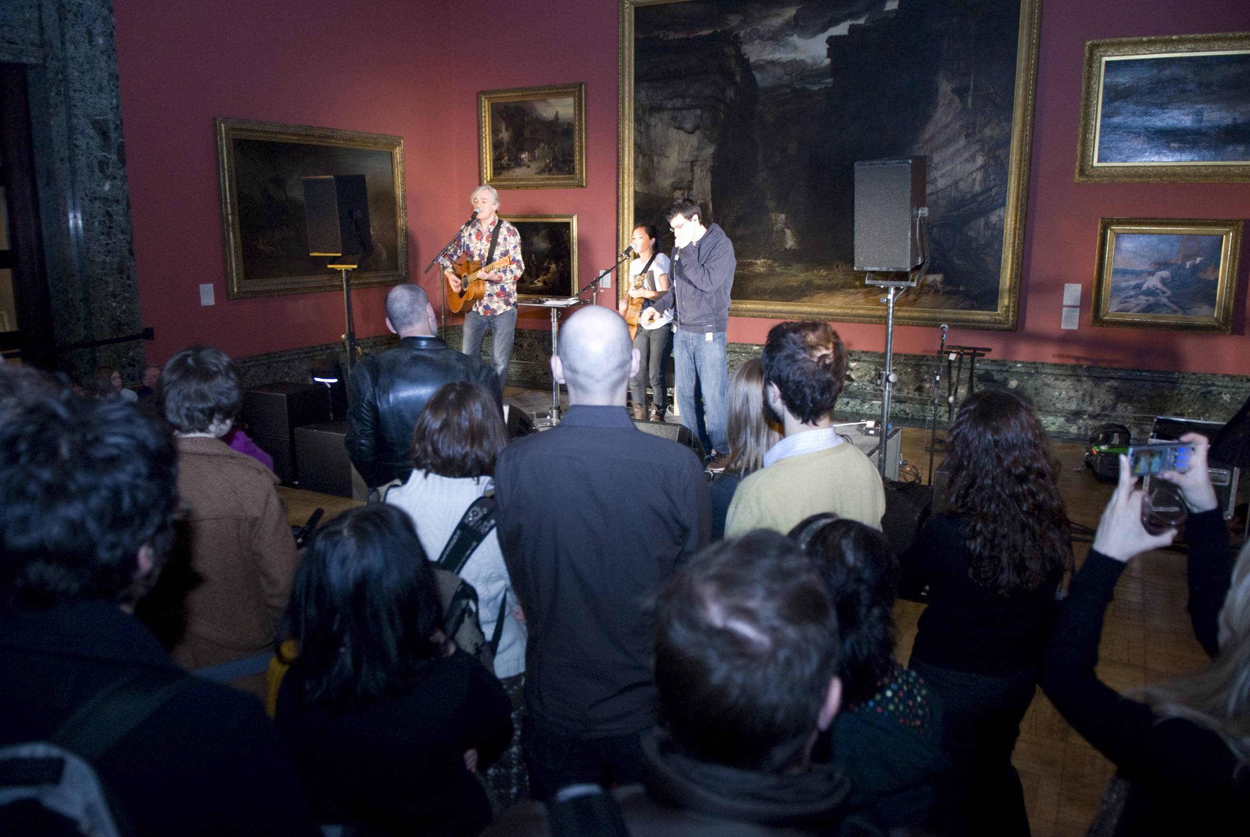 musicians perform in a gallery setting